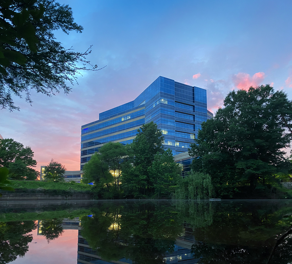Fairfax County Public Safety Headquarters building at sunset with pond